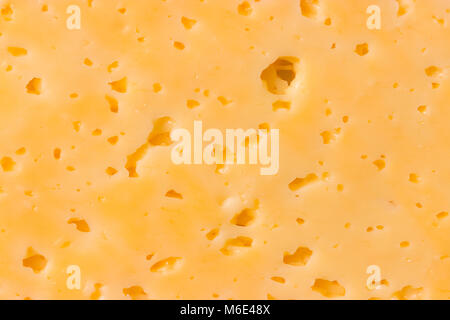 Cheese surface with openings close up texture Stock Photo