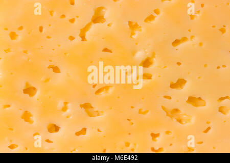 Cheese surface with openings close up texture Stock Photo