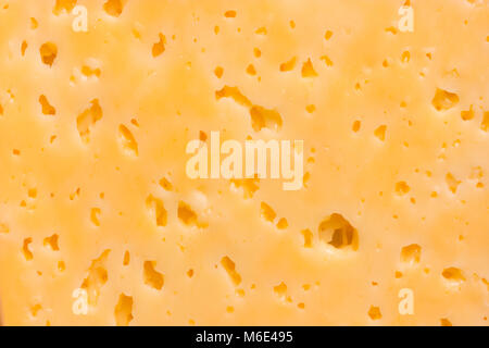 Cheese surface with openings close up texture Stock Photo