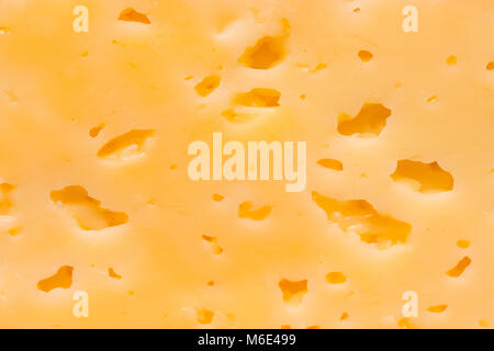 Cheese surface with openings close up texture Stock Photo