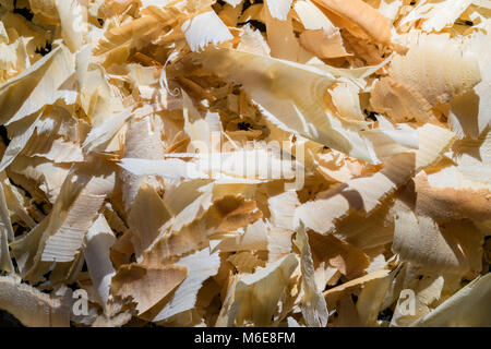 Curly white and yellow big sawdust on black background Stock Photo