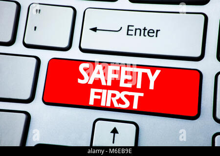 Handwriting Announcement text showing Safety First. Business concept for Safe Warning written on red key the keybord background. Stock Photo