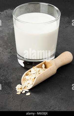Vegan oat milk in glass on a dark background Stock Photo