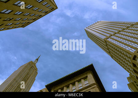 The iconic  Empire State Building and other high rises, view at the low angle, in New York City, New York, United States. Stock Photo