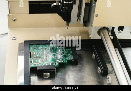 Automation of machine assembly of computer circuit board in the factory for the production of computer components. The process of soldering the board. Stock Photo