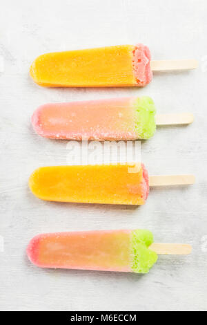 Multiple Color Popsicle Multi-colored popsicles on a white background. Top view. Food ...