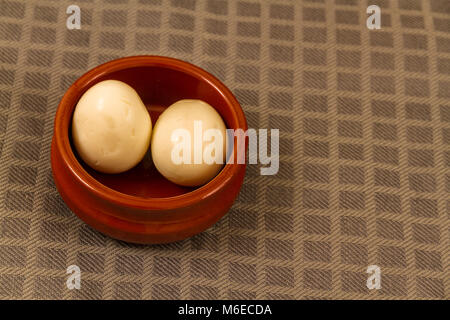 Two pickled eggs in ceramic bowl Stock Photo