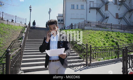 Muslim talking about business by phone and putting hands up Stock Photo