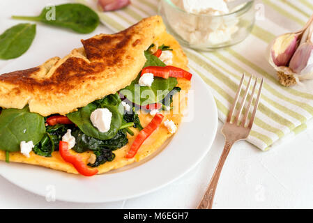 Omelet with spinach, ricotta cheese and red pepper. Stock Photo