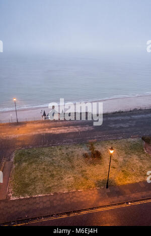 Victoria Parade, Ramsgate; walking along the seafront during a snow flurry in February. Stock Photo