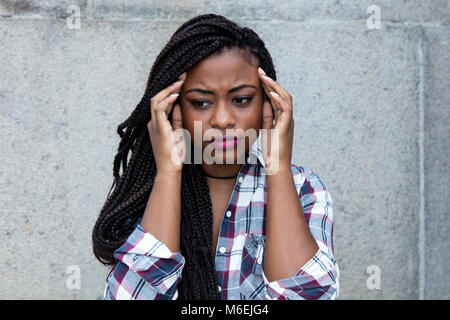 Beautiful african woman with painful headache outdoors with copy space Stock Photo