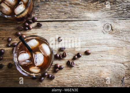 Black Russian Cocktail with Vodka and Coffee Liquor. Homemade Alcoholic Boozy Black Russian drink with coffee beans on wooden background. Stock Photo