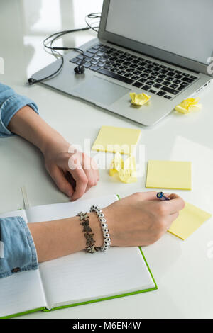Female hands writing ideas on paper Stock Photo