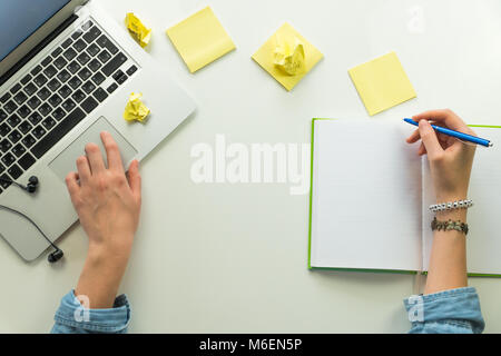 Minimalistic home office work place with laptop and note pad Stock Photo