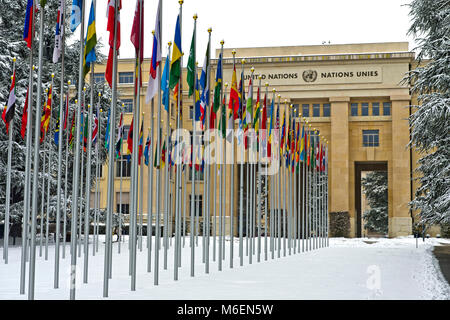 Snowcovered court of flags at the United Nations Office at Geneva, UNO, Palais des Nations, in winter time, Geneva, Switzerland Stock Photo