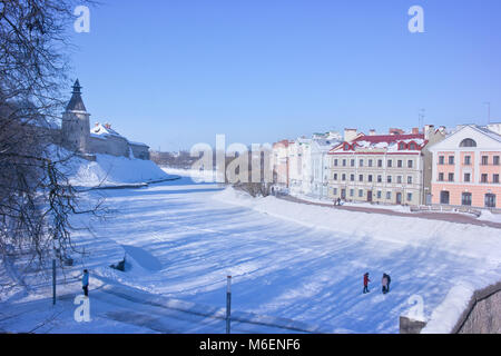 PSKOV, RUSSIA-February 21.2010: Pskova River. Tower of the Pskov fortress and the beautiful facades of modern houses on Sovetskaya embankment Stock Photo