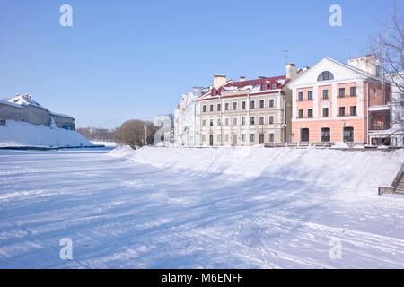 PSKOV, RUSSIA-February 21.2010: Pskova River. Tower of the Pskov fortress and the beautiful facades of modern houses on Sovetskaya embankment Stock Photo