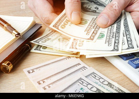 Businessman counting US dollars bills. Small business concept. Stock Photo