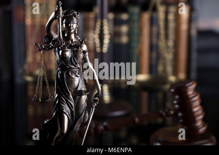 Law symbols on book background. Statue of justice, gavel and books. Stock Photo