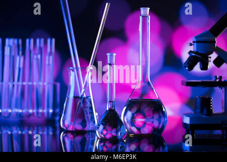 Science laboratory. Laboratory glassware, microscope, test tubes. Research and development. Bokeh background. Stock Photo