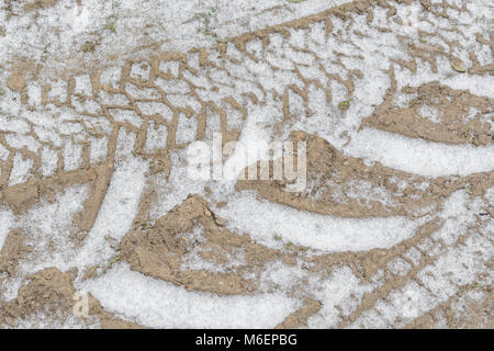 Tractor tyre marks infilled with snow during the 2018 'Beast from the East' cold snap. Stock Photo