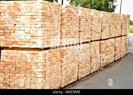 Several pallets with concrete brick stacked on top of each other in depot. Stock Photo