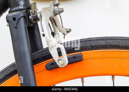 Some of old bicycle brakes on white wall. Stock Photo