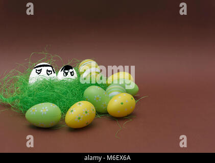 Anger eggs hidden in the grass. Easter funny eggs, Commando eggs, revenge Stock Photo