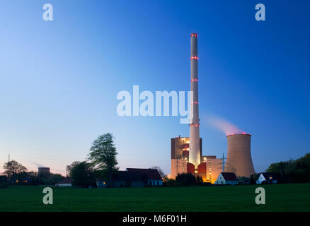 Living houses in front of a coal-fired power station in Germany. Stock Photo