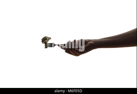 Vegetable on fork in female hand Stock Photo