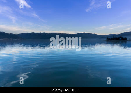 The blue Danube river as it flows past the small town of Orsova in Romania on the border with Serbia Stock Photo