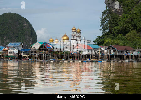 The 'sea gypsy' village of Koh Panyee with its golden domed mosque is built entirely on stilts in the Phang Nga bay of southern Thailand Stock Photo