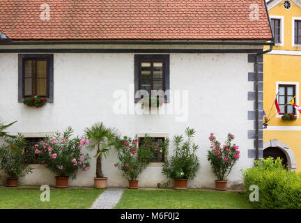 Facade of a flower decorated historic building in Slovenia Stock Photo