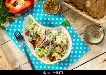 Easter recipe, festive snack. Salad with Pekinese cabbage, herring, sweet pepper and onions - on the festive table. Stock Photo