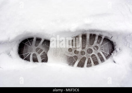 Walking boot footprint in snow Stock Photo