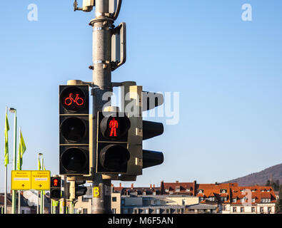 Red lights for pedestrians and cyclists with a graduated blue sky as background and copy space. Stock Photo