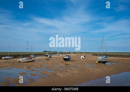 Boats grounded at low tide in the harbour at Wells-next-the-Sea, Norfolk, England] Stock Photo