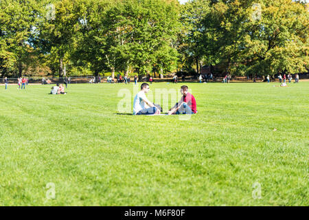 New York City, USA - October 28, 2017: Manhattan NYC Central park with couple people sitting having picnic on great lawn grass meadow in autumn fall s Stock Photo
