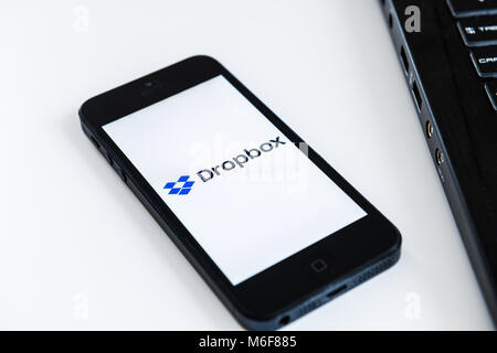 Herndon, Virginia - February 28, 2018: Black iPhone 5 apple phone smartphone mobile screen for dropbox clouds storage app application on table isolate Stock Photo