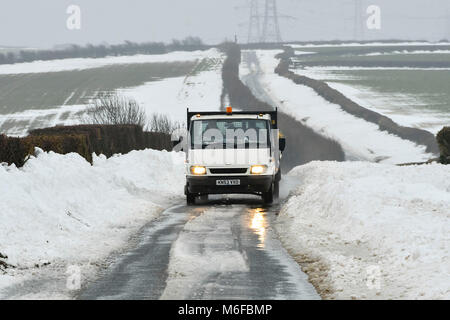 Compton Valence, Dorset, UK.  3rd March 2018.  UK Weather.  A van driving along the Roman Roan near Compton Valence in Dorset, flanked by large snow drifts from Storm Emma.  The snow is begining to thaw with most of the fields almost snow free but the drifts along the roads remain and in places are 4-5 feet high.  Picture Credit: Graham Hunt/Alamy Live News Credit: Graham Hunt/Alamy Live News Stock Photo