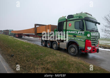 Heavy haulage trucks carrying metal for bridge construction for the 2018 Ely Bypass. Parked in layby awaiting for delivery. Largest load 150 Tonns (load and truck), 45m long. Ironwork carried from southern Wales to Ely. Stock Photo