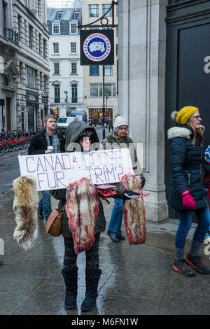 London, UK, 3rd March 2018. Animal rights protest outside the Canada Goose store in Regent Street. Activists have regularly protested outside since the store opened in Autumn 2017. Canada Goose parker jackets are made using a Coyote fur trim. Activists also oppose Canada Goose’s use of bird feathers in down filled jackets. Credit: Steve Bell/Alamy Live news Stock Photo