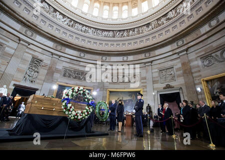President Donald J. Trump and First Lady Melania Trump present a memorial wreath as they pay their respects to the Rev. Billy Graham, who lays in honor in the rotunda of the U.S. Capitol, Wednesday, Feb. 28, 2018, in Washington, D.C., only the fourth private citizen and first religious leader so honored. Credit: Storms Media Group/Alamy Live News Stock Photo