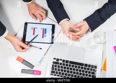 Modern business workplace flat lay. Concept of two businessmen working at modern minimalistic desk on financial project or task top view Stock Photo