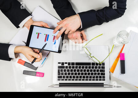 Modern business workplace flat lay with laptop, tablet pc and papers. Stock Photo
