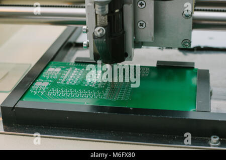Automation of machine assembly of computer circuit board in the factory for the production of computer components. The process of soldering the board. Factory for the production of microchips. Stock Photo