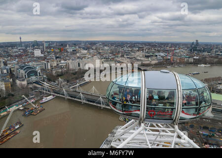 London, United Kingdom, February 17, 2018:Close up of the London Eye in London, Great Britain with tourist holding capsule in view. special view of Skyline of City of London. Stock Photo