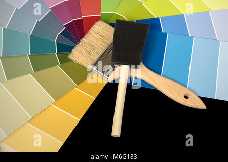 foam brush and paint brush tools on colorful paint chips Stock Photo