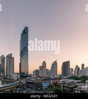 BANGKOK, THAILAND - MARCH 03, 2018: Bangkokâ€™s BTS sky train makes its way to the Chong Nonsi station near Bangkokâ€™s tallest building. Stock Photo