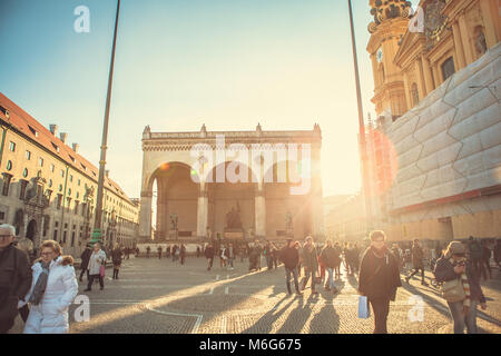 Munich, Germany, December 29, 2016: The Odeonsplatz is an area in the center of Munich. Everyday life in Munich. A lot of people in the square. Stock Photo